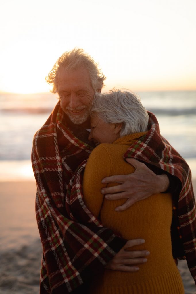 Old couple in love at the beach